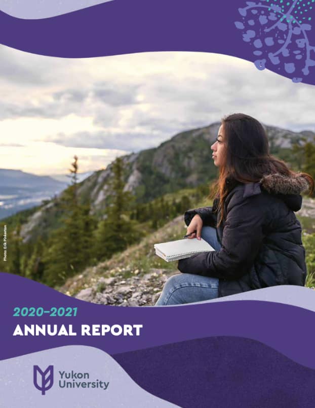 Cover of 2021 annual report. A photo of a woman sitting on a mountain with a notebook and pen in her hand