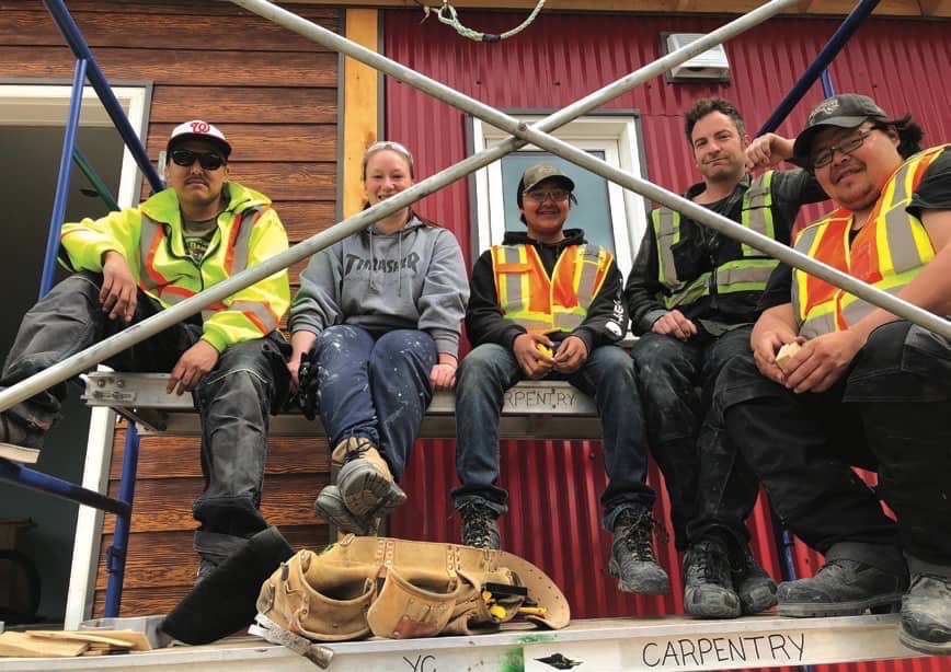 (Left to Right) Merlin Charlie, Shannon Holmes, William Burns, Simon Vincent, and Phil Asp working on the house.