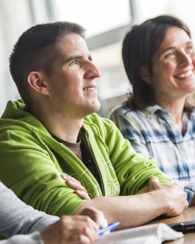 Two students paying attention in class