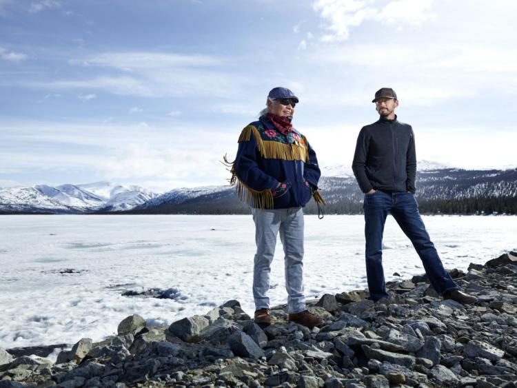 men by a lake