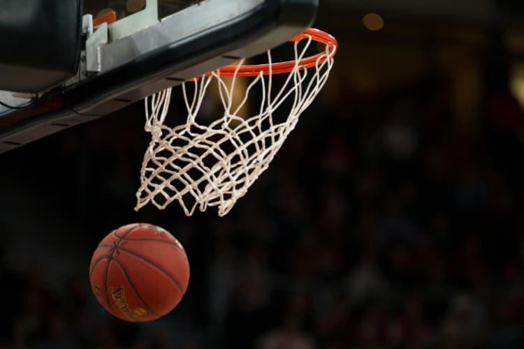 A basketball sails through a basket