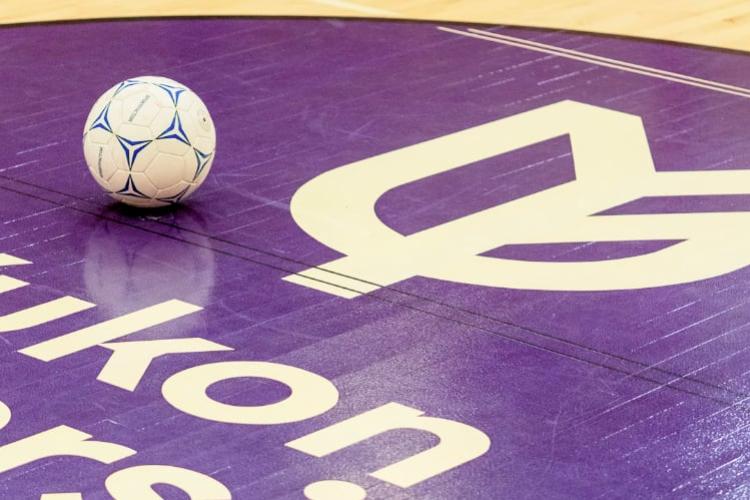 Soccer ball on a gym floor with the Yukon University logo painted on it