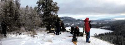 Northern Outdoor Pursuits and Leadership students standing atop a hill with snow shoes