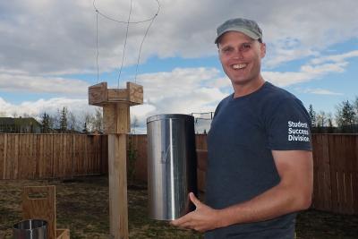 john holding one of the microplastic traps