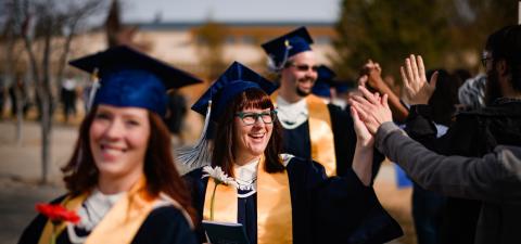 graduates receive high fives