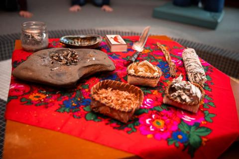 A smudge kit on top of a red hankie with a floral design