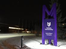 Campus sign at night