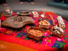 A smudge kit on top of a red hankie with a floral design